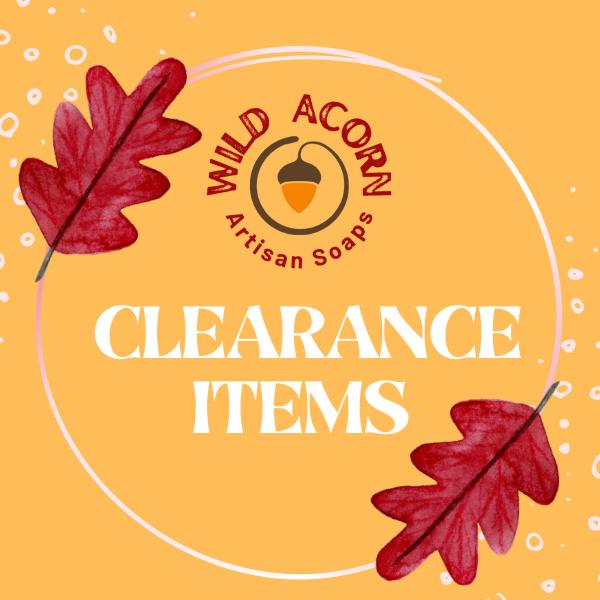 yellow background with the words "Clearance Items" inside a white circle with red oak leaves and the Wild Acorn Artisan Soaps logo inside the circle
