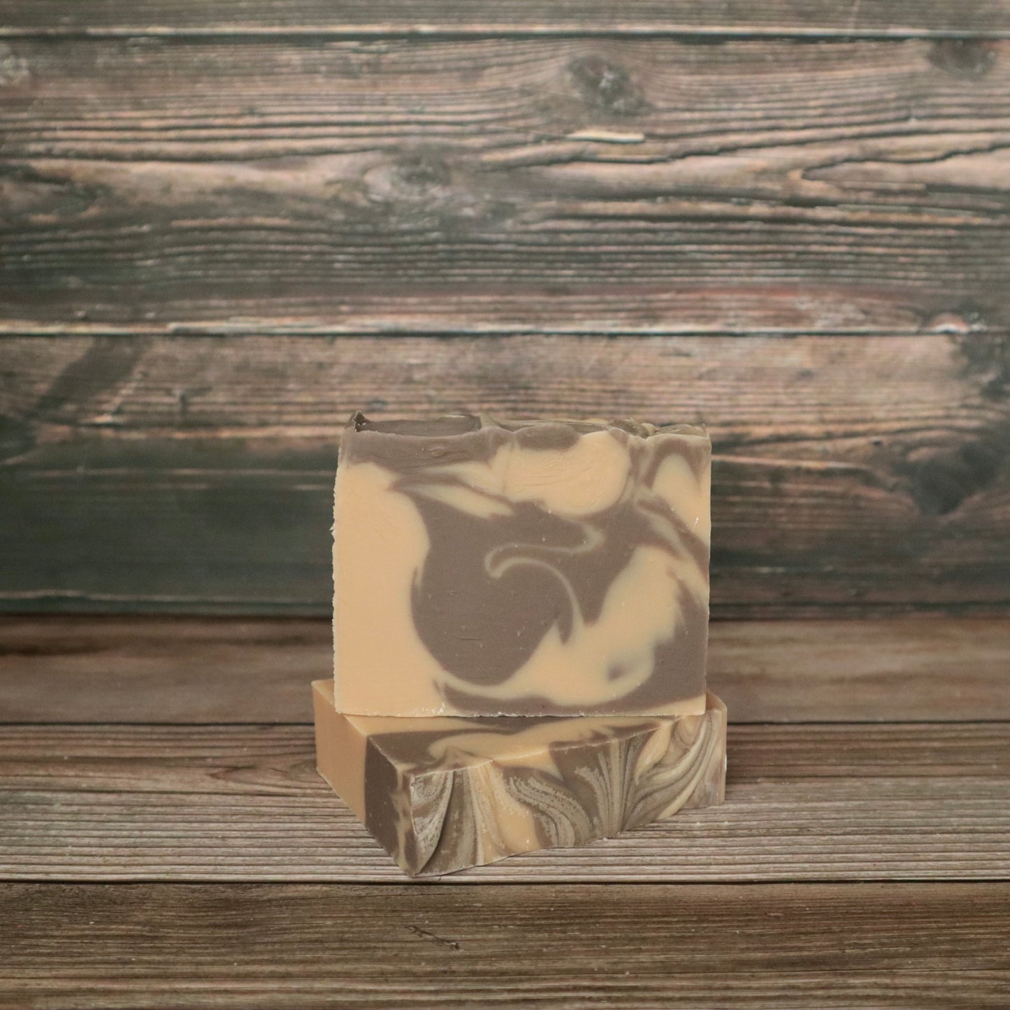 picture of soap with brown and cream colored swirls with slight swirl on top for design