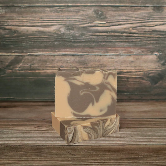 picture of soap with brown and cream colored swirls with slight swirl on top for design