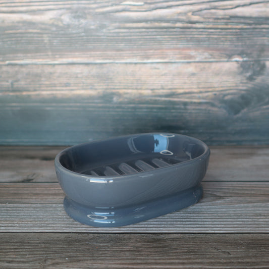 Shiny gray oval soap dish, empty, side veiw.