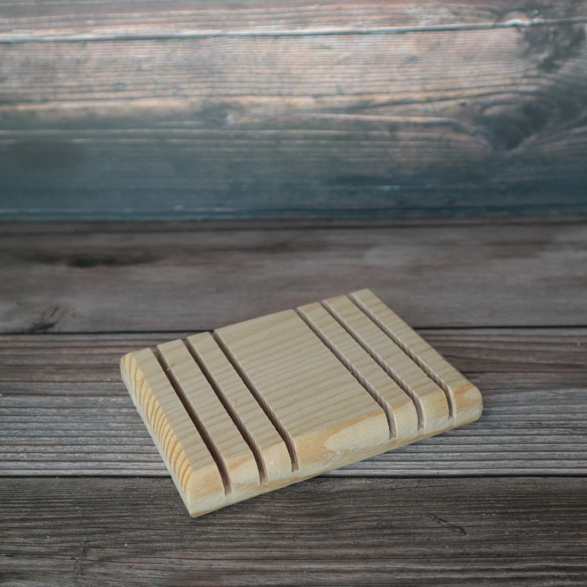 wooden soap dish with grooves in them to catch the soap