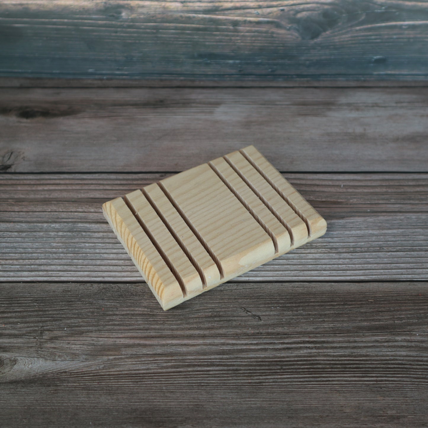 wooden soap dish with grooves in them to catch the soap