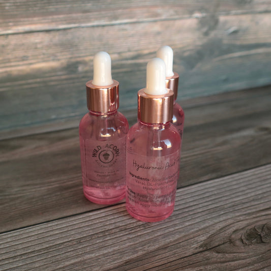 3 pink dropper bottles with white tips.